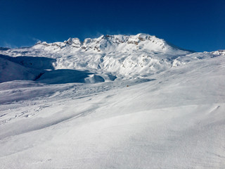 Fototapeta na wymiar A thick blanket of frozen snow covers the slopes towards the San Bernardino pass in Switzerland.