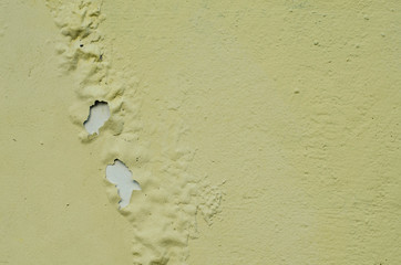Old rusty surface. The paint is climbing off the wall. Old cracked paint. The wall is rusting.