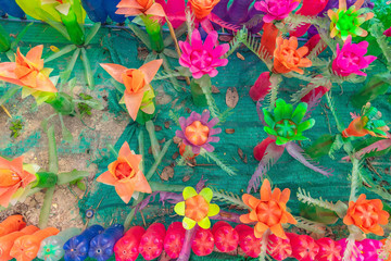 Recycled colorful plastic flowers made from plastic bottles to decorate as flowers in the garden. Plastic bottle recycled.