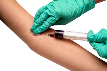 Closeup of female hands of nurse taking blood sample from patient isolated on white background....