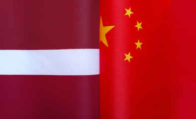 fragments of national flags of the Republic of Latvia and China in close-up