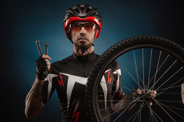 guy-cyclist in a Bicycle helmet with a Bicycle wheel