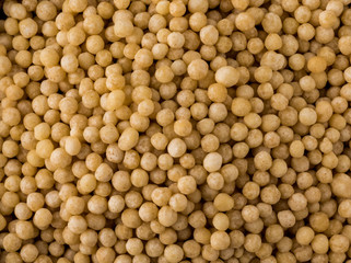 Top down close up view of a heaping pile of Israeli couscous.