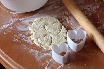 Valentine's. Day or love baking. Pastry and heart shaped molds on the table. Home made cookies.