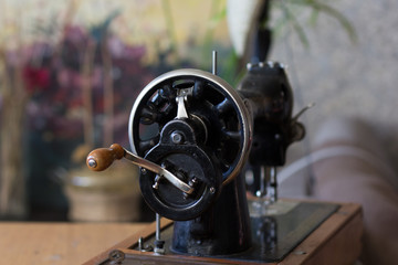 Machine pulley with wooden handle as part of the old manual sewing machine