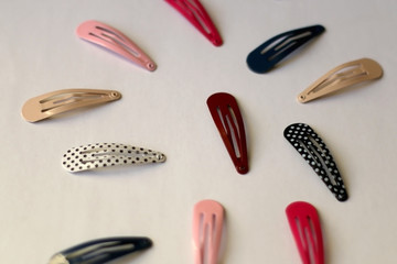 Fashionable colorful hair clips on white background. Selective focus.