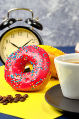 doughnuts and a Cup of coffee on a yellow-blue background, space for text