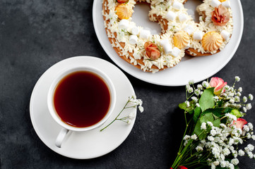 tea and cake in the form of 8 is decorated with flowers, cream cheese, marshmallows, Bizet on a stone background. romantic delicious breakfast on International Women's Day March 8