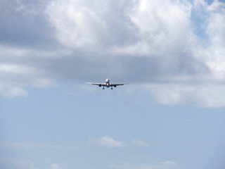 Wide shot of the skies with an airplane flying