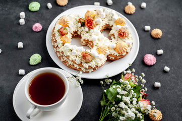 tea and cake in the form of 8 is decorated with flowers, cream cheese, marshmallows, Bizet on a stone background. romantic delicious breakfast on International Women's Day March 8
