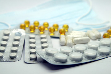 blisters with pills and medical mask close-up