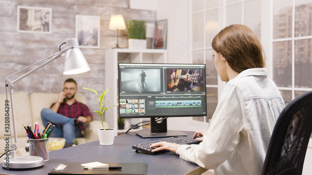 Poster side view of video editor working on a project