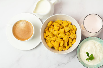 black coffee, cereal, milk and yogurt top view