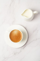 black coffee and milk on a white background top view