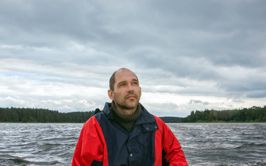 Mature Man Against A Overcast Landscape With A Lake