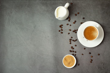 black coffee in a white cup, milk and brown sugar