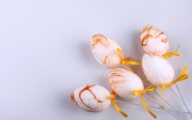 decorative Easter eggs painted in pastel colors on a light background