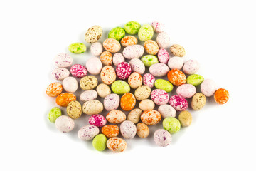 Fototapeta na wymiar colored sweet candy peanuts in icing, similar to bird eggs on a white background