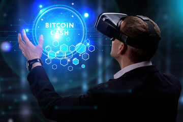 Business, Technology, Internet and network concept. Young businessman working on a virtual screen of the future and sees the inscription: Bitcoin cash