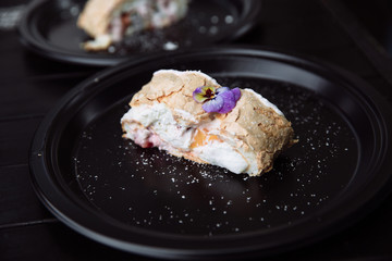 Meringue roulade with cream. 