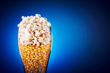 Beer glass filled with popcorn and corn kernels