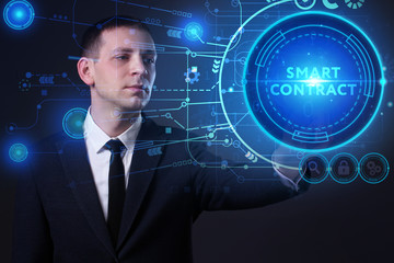 Business, Technology, Internet and network concept. Young businessman working on a virtual screen of the future and sees the inscription: Smart contract