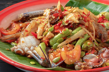 thai seafood salad mixed with Papaya, chopped on colorful tray
