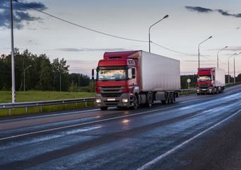 Trucks Semi-trailers Transporting cargo on a suburban highway