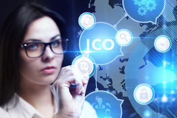 Business, Technology, Internet and network concept. Young businessman working on a virtual screen of the future and sees the inscription: ICO