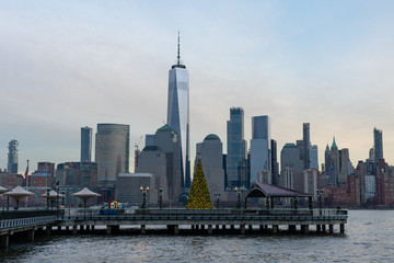 Lower Manhattan New York City Skyline seen from Jersey City with a Christmas Tree during a Sunset