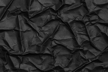 Black crumpled paper texture or background