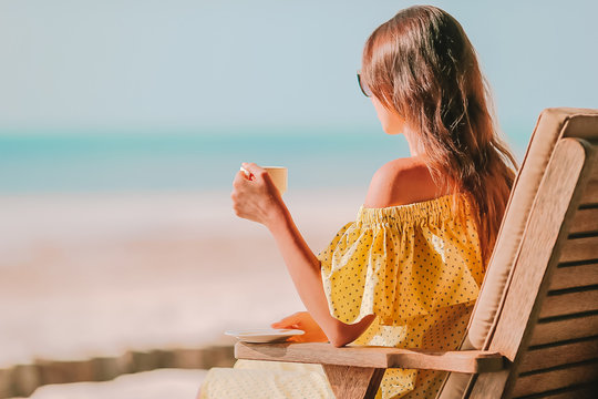 Young Woman With Hot Coffee Enjoying Beach View