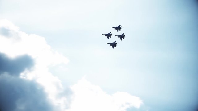 Four fighter jets in the blue sky. A general plan. Aerobatic figures. Airshow. 60fps