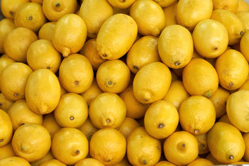 Background of yellow lemons. A lot of yellow lemons sold on the market