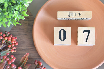 July 7, month design with flower and earthenware.