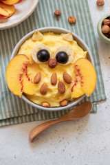 Kids breakfast polenta porridge with fruit look like a cute owl