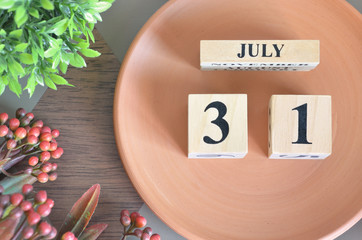 July 31, month design with flower and earthenware.