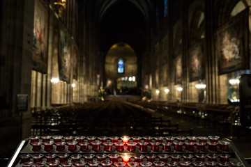 Lighting candles in a catholic temple .