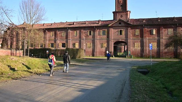 Venaria Reale, Piedmont, Italy. January 2020. "La Mandria" regional park, view of the royal hunting lodge. View of the rear entrance, a long avenue with a dirt road leads to it. Red brick facade.