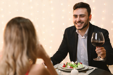 Handsome Man Making Toast On Romantic Dinner With His Girlfriend