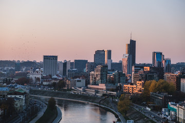 Vilnius modern financial district panorama at dusk from Gediminas tower with Neris river running in between