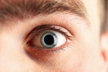 Beautiful mans blue eye, closeup. Macro. Healthcare and medical concept