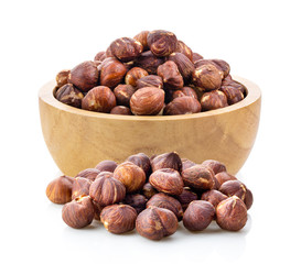 hazelnuts in wood bowl  on white background