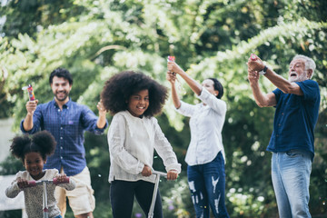A happy family, grandfather, father, mother and daughter.