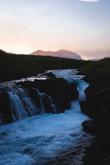Hlauptungufoss waterfall during sunset in Summer