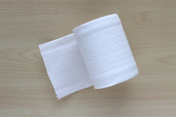 Roll of toilet paper or tissue on wooden background