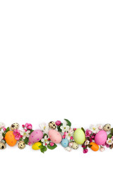 Obraz na płótnie Canvas Easter decoration. Pink flowers apple tree and colored easter eggs and quail eggs on white background with space for text. Top view, flat lay