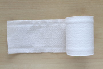 Roll of toilet paper or tissue on wooden background