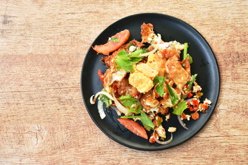 spicy batter fried egg slice with chop chicken meat Thai salad on plate