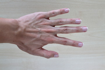 Empty Hand showing gesture on wood background